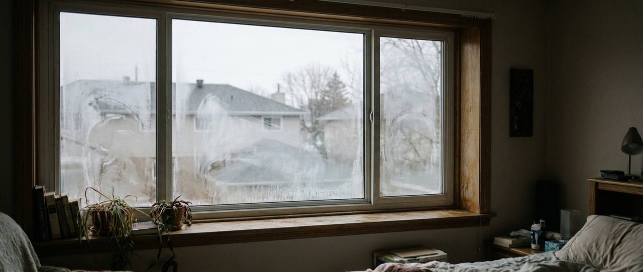 Double-pane window with condensation fog trapped between the glass panes