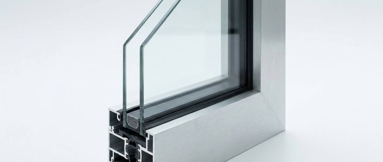 Corner detail of a double-pane insulated glass unit showing the spacer and glass layers